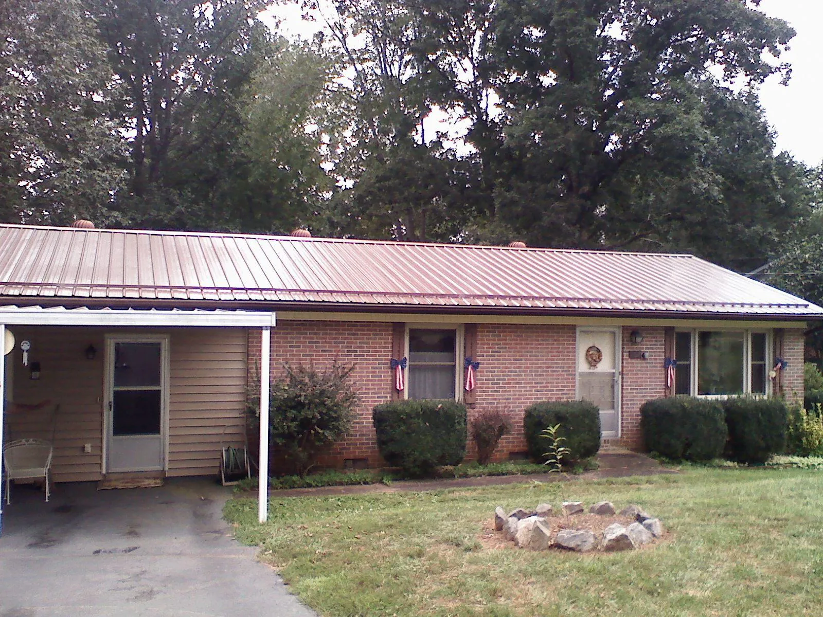 Bronze metal roof and carport on a brick ranch home — Roof Repair work by our crew in Brinklow
